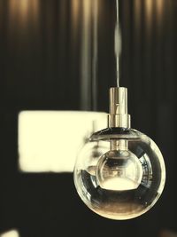 Close-up of light bulb on table