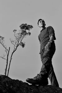 Low angle view of man standing against sky