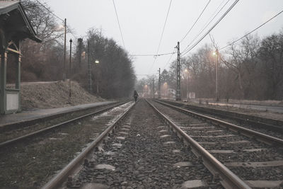 Railroad tracks against sky during rainy season