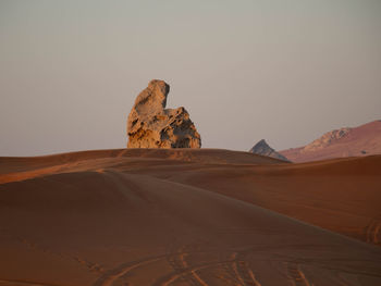 Rock formations in desert against sky