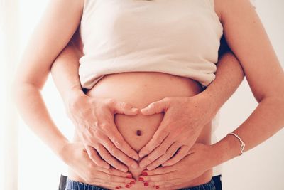 Midsection of father with hand touching hair