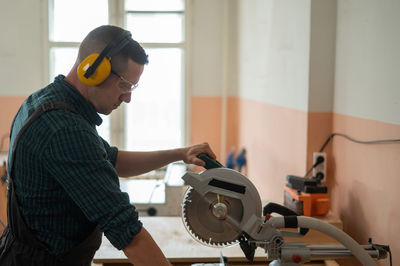 Side view of man working at workshop