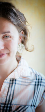 Cropped image of smiling woman against wall