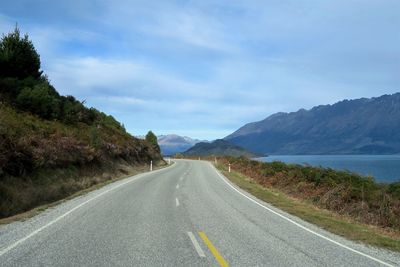 Empty road along countryside landscape