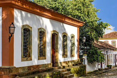 Facade of old colorful colonial houses on a cobbled street in the historic city of tiradentes