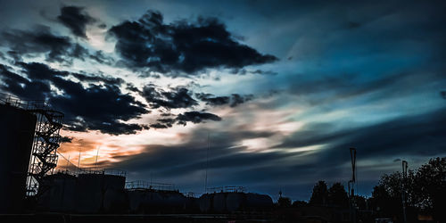 Low angle view of silhouette buildings against sky during sunset