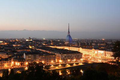 Illuminated government building in city at dusk