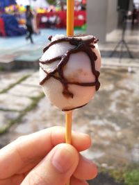 Cropped hand of person holding street food