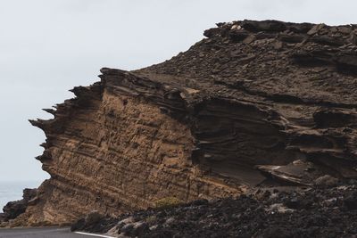 Low angle view of rock formation against sky