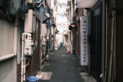 Narrow street amidst buildings in city