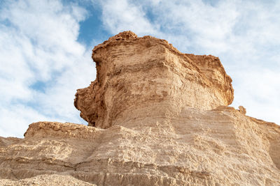 Low angle view of rock formations against sky