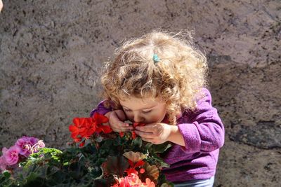 Cute girl smelling flowers