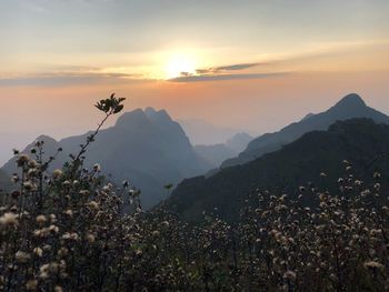 Scenic view of mountains against sky at sunset