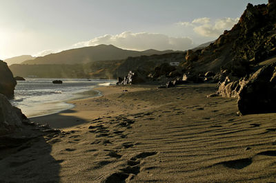 Scenic view of beach against sky during sunset