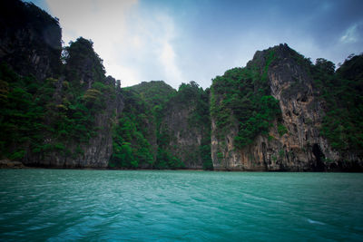 Scenic view of sea and mountains against sky