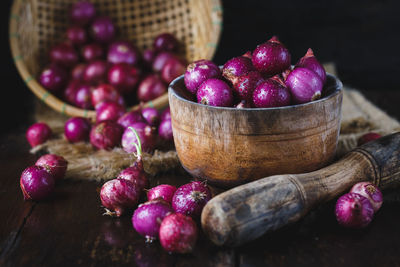 Close-up of wet shallots with mortar and pestle on table