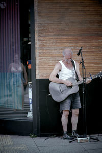 Full length of man playing guitar