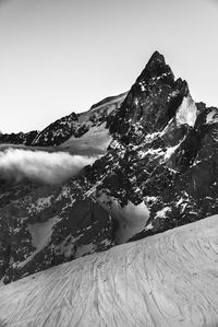 Low angle view of snowcapped mountain against sky