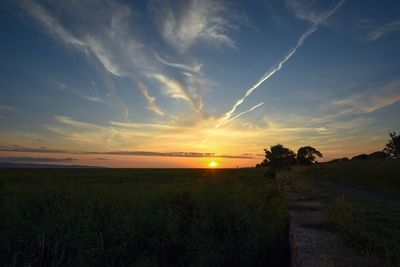 Scenic view of field against sky during sunset