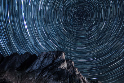 Blurred motion of mountain against sky at night