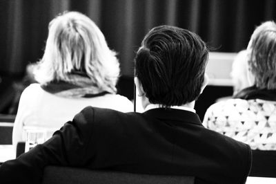 Rear view of people sitting in auditorium