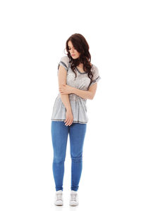 Full length of young woman standing against white background