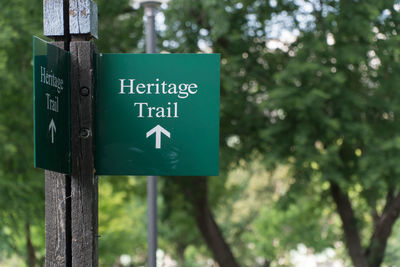 Close-up of road sign against trees