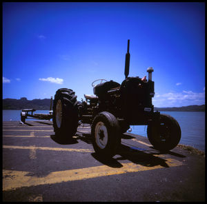 Vintage car on road against blue sky