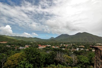 Town by mountains against sky