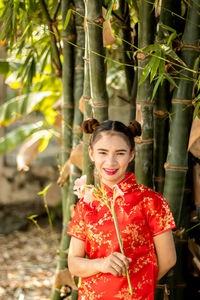 Portrait of a smiling young woman standing outdoors