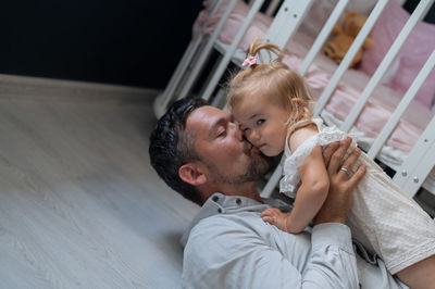 Father and baby on bed