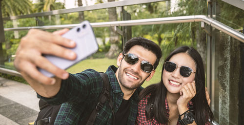 Young couple doing selfie while standing outdoors