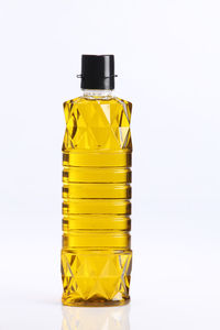 Close-up of yellow bottle against white background