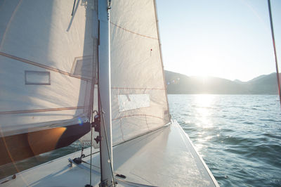 Sailboat sailing on sea against clear sky