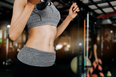 Midsection of woman standing at home