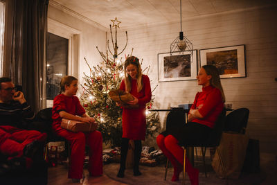 Father and daughters opening christmas presents