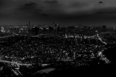 Aerial view of illuminated cityscape against sky at night