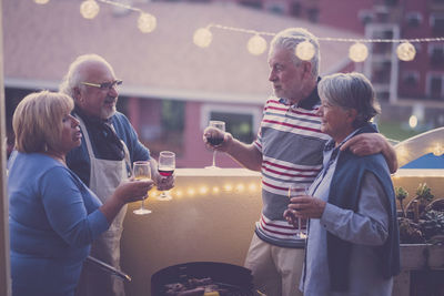 Rear view of people standing at market stall