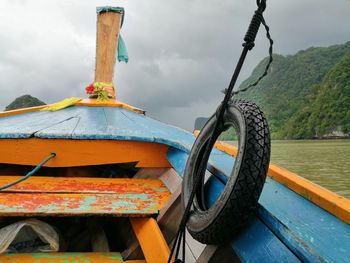 Ship moored on river against sky