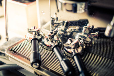 Close-up of portafilters on coffee machine