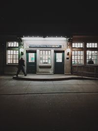 Man standing in illuminated room