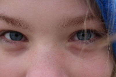 Close-up portrait of smiling teenage girl standing outdoors during winter