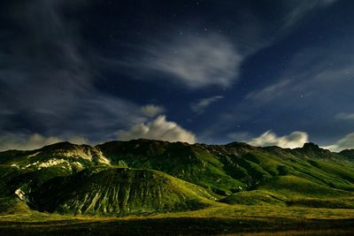 Scenic view of landscape against sky at night