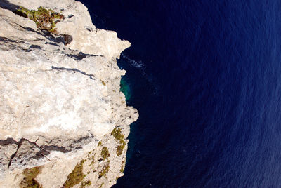 High angle view of rock formation on beach against sky