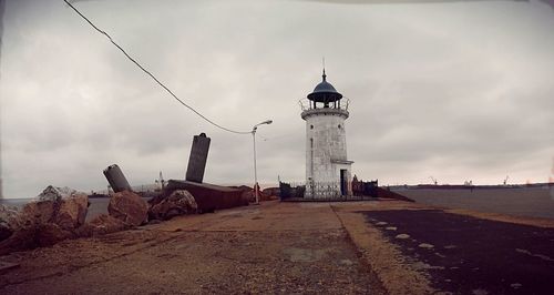 Lighthouse against cloudy sky