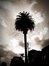 Low angle view of silhouette palm trees against sky