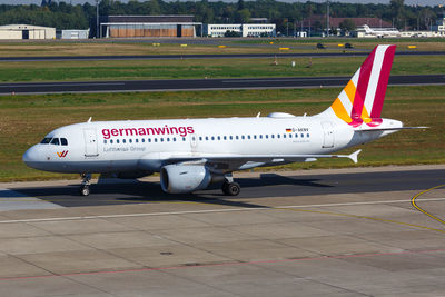 Side view of airplane on runway