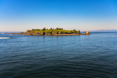 Scenic view of sea against clear blue sky