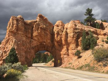 Road amidst rocks against sky