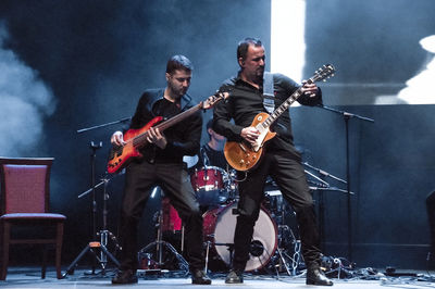 Man playing guitar at music concert